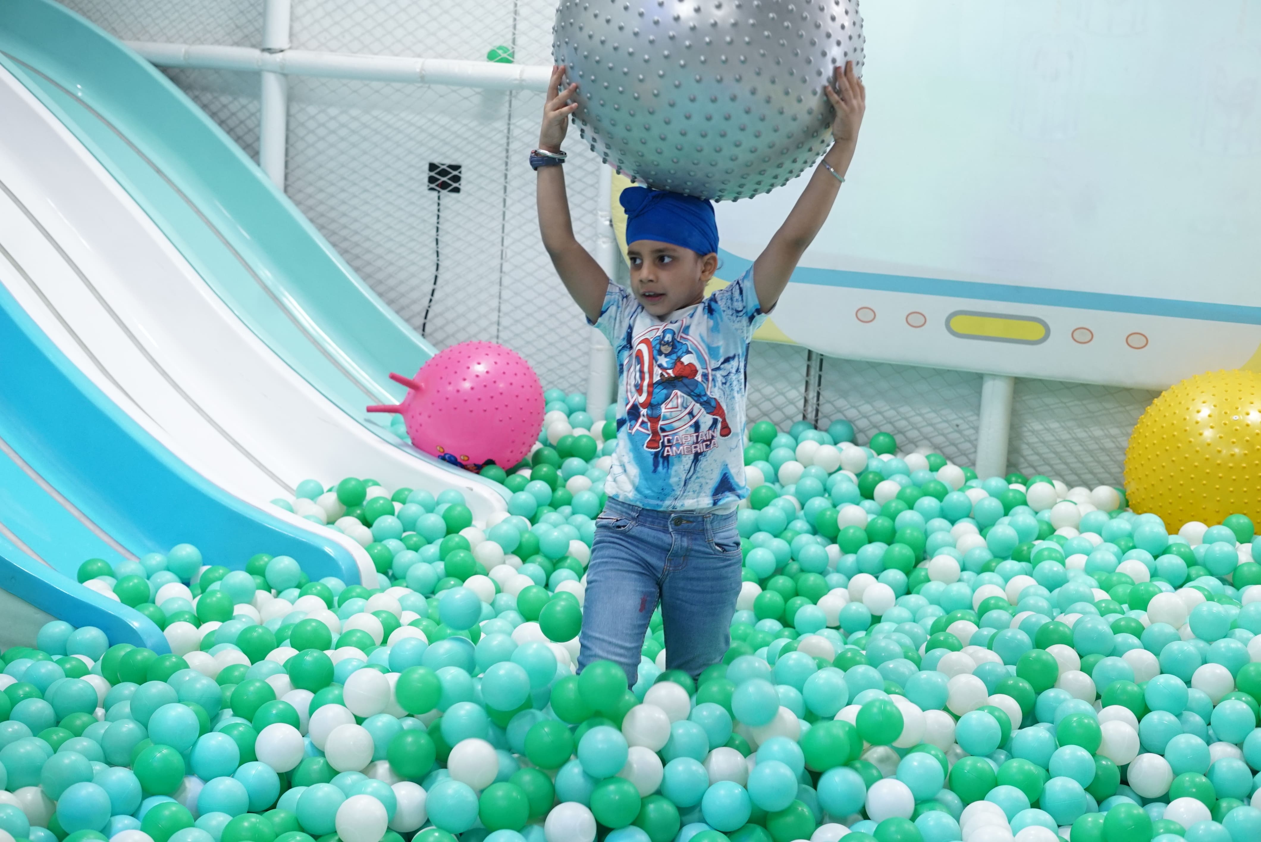 Child in ball pool Ooodles Doodles play area