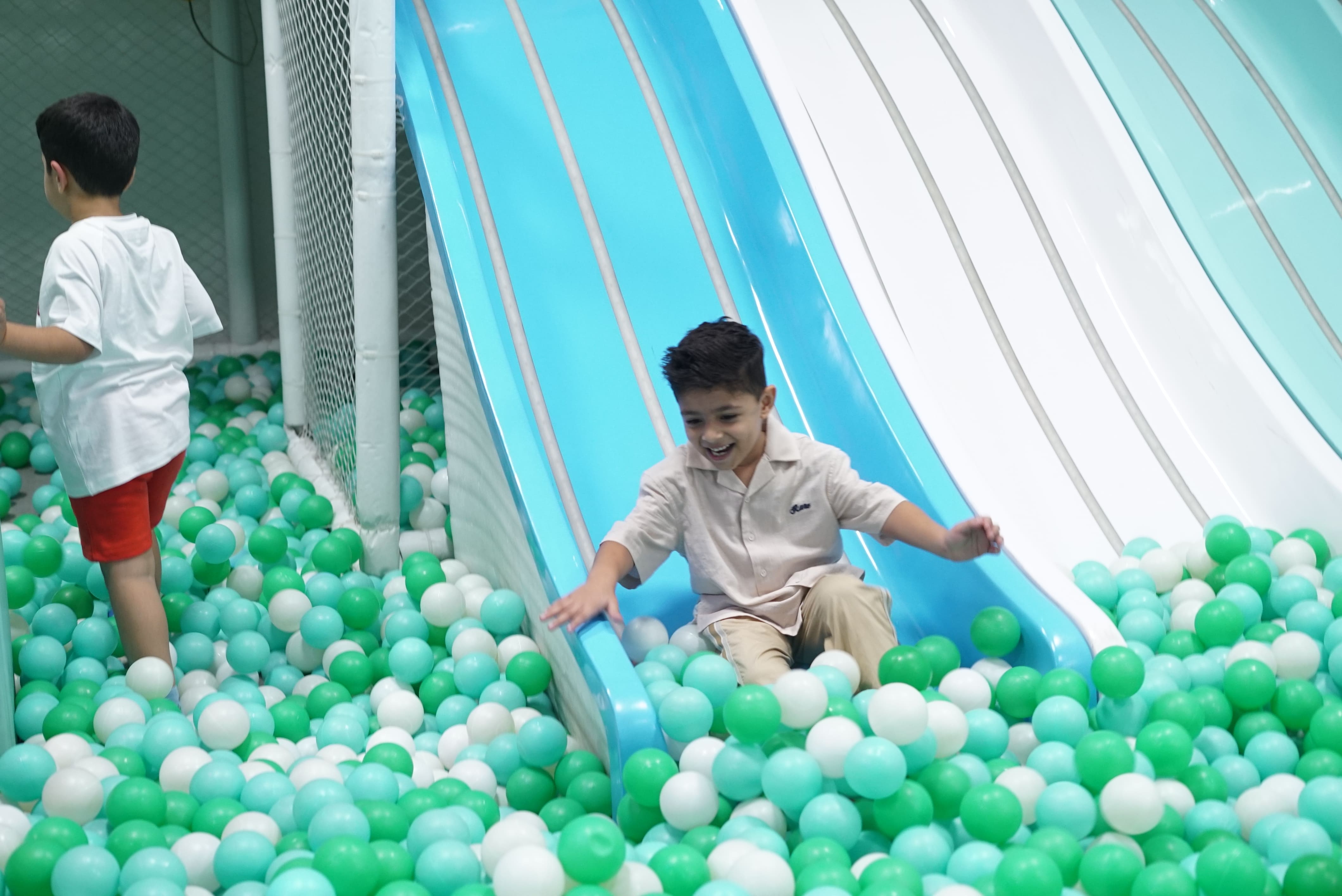 Kids sliding into ball pool Ooodles Doodles Faridabad